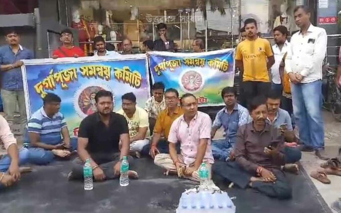 Members of the Puja Committee protested in front of the shopping mall